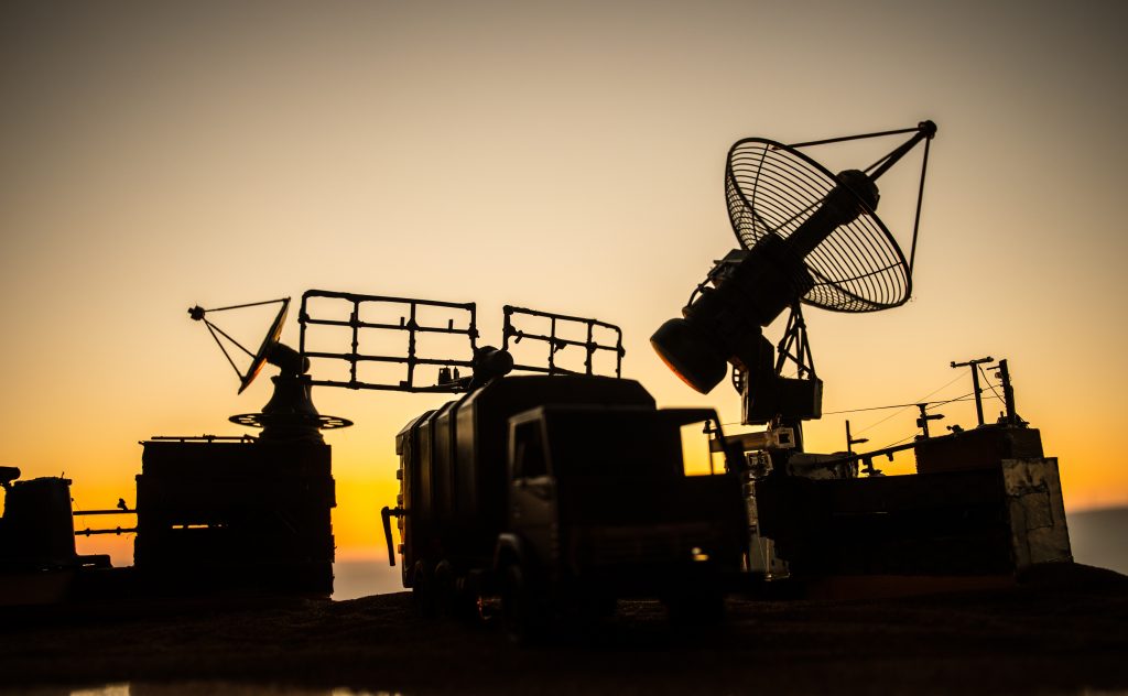 Satellite dishes or radio antennas against evening sky. Selective focus